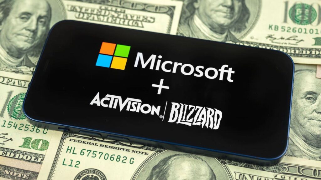 Il logo di Microsoft ed Activision Blizzard su un letto di banconote