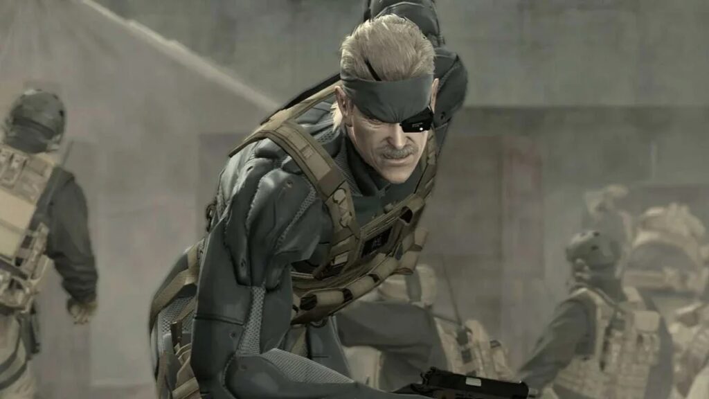 Old Snake di Metal Gear Solid 4 in primo piano mentre sta cadendo in ginocchio