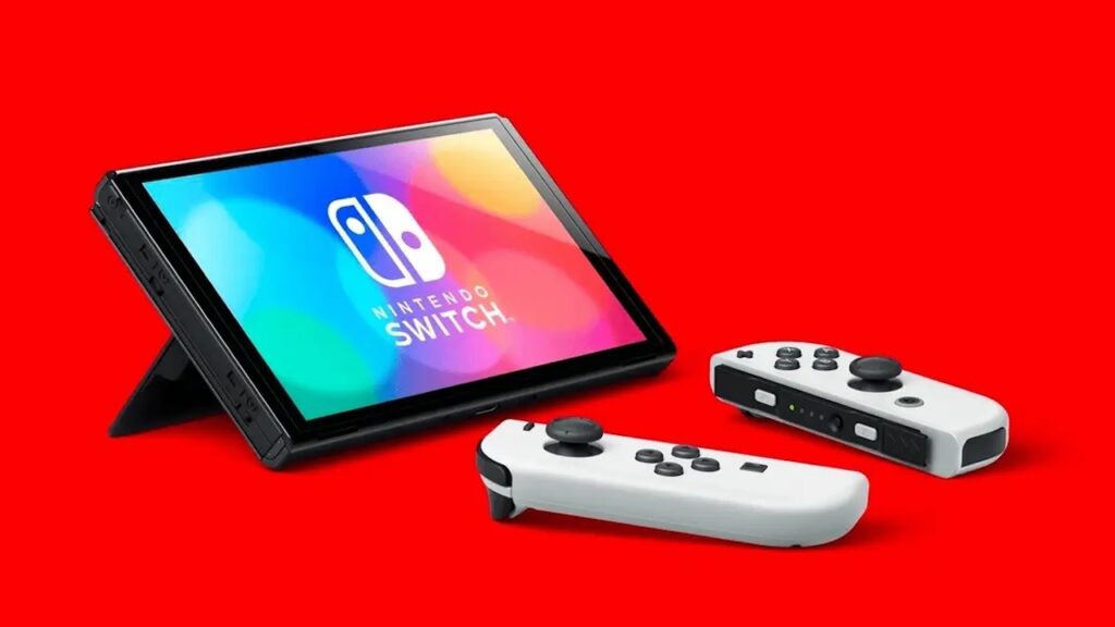 Una Nintendo Switch modello OLED su uno sfondo rosso