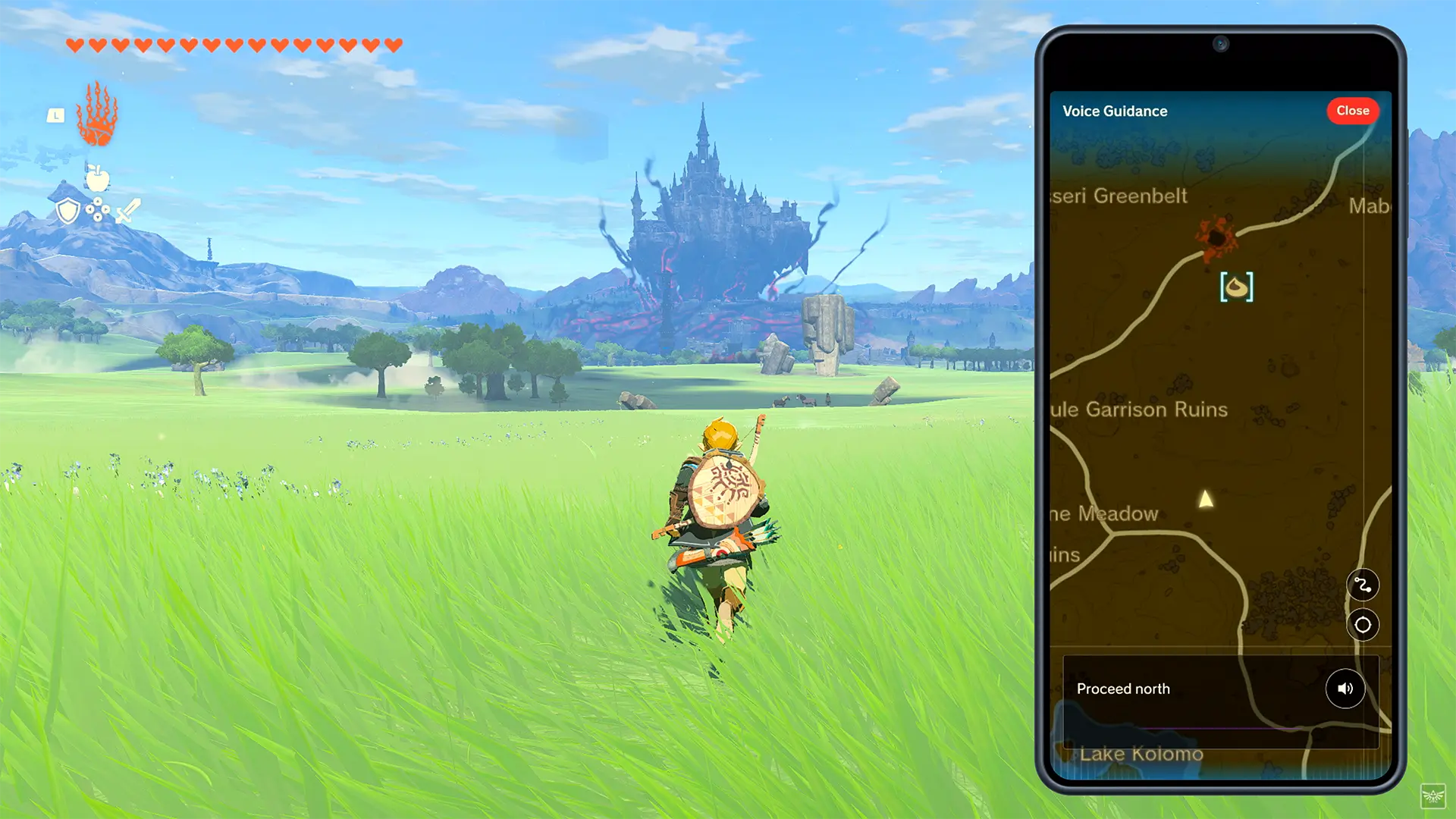 link corre nella prateria di Hyrule con il castello in lontananza e l'app del telefono smartphone