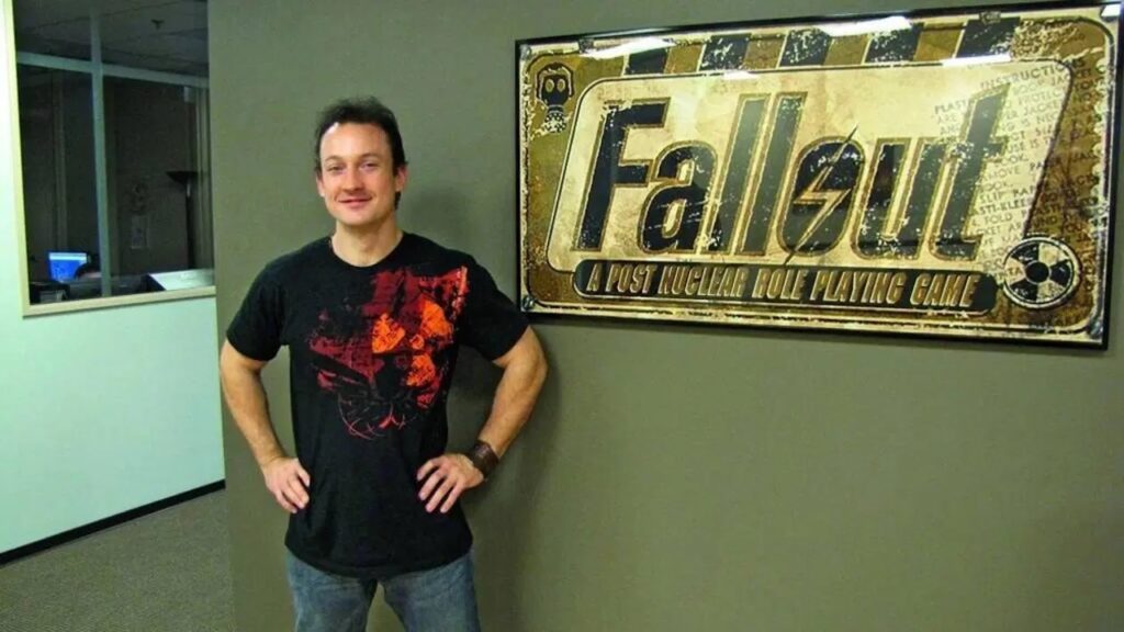 Chris Avellone con dietro il logo di Fallout: New Vegas