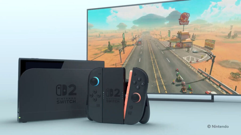 Un Nintendo Switch 2 con dietro un televisore con Mario Kart World