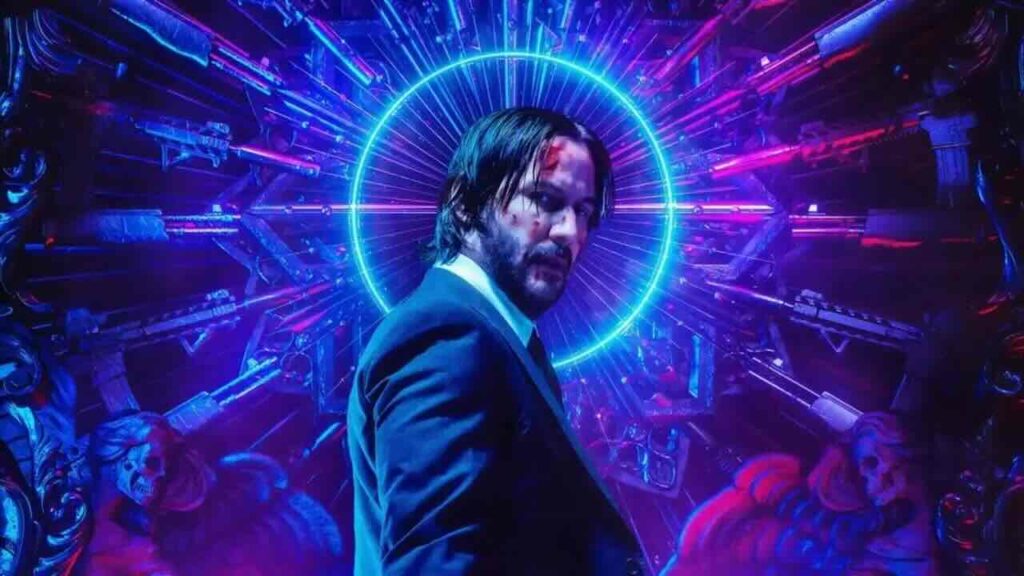 John Wick con delle armi vicino alla testa